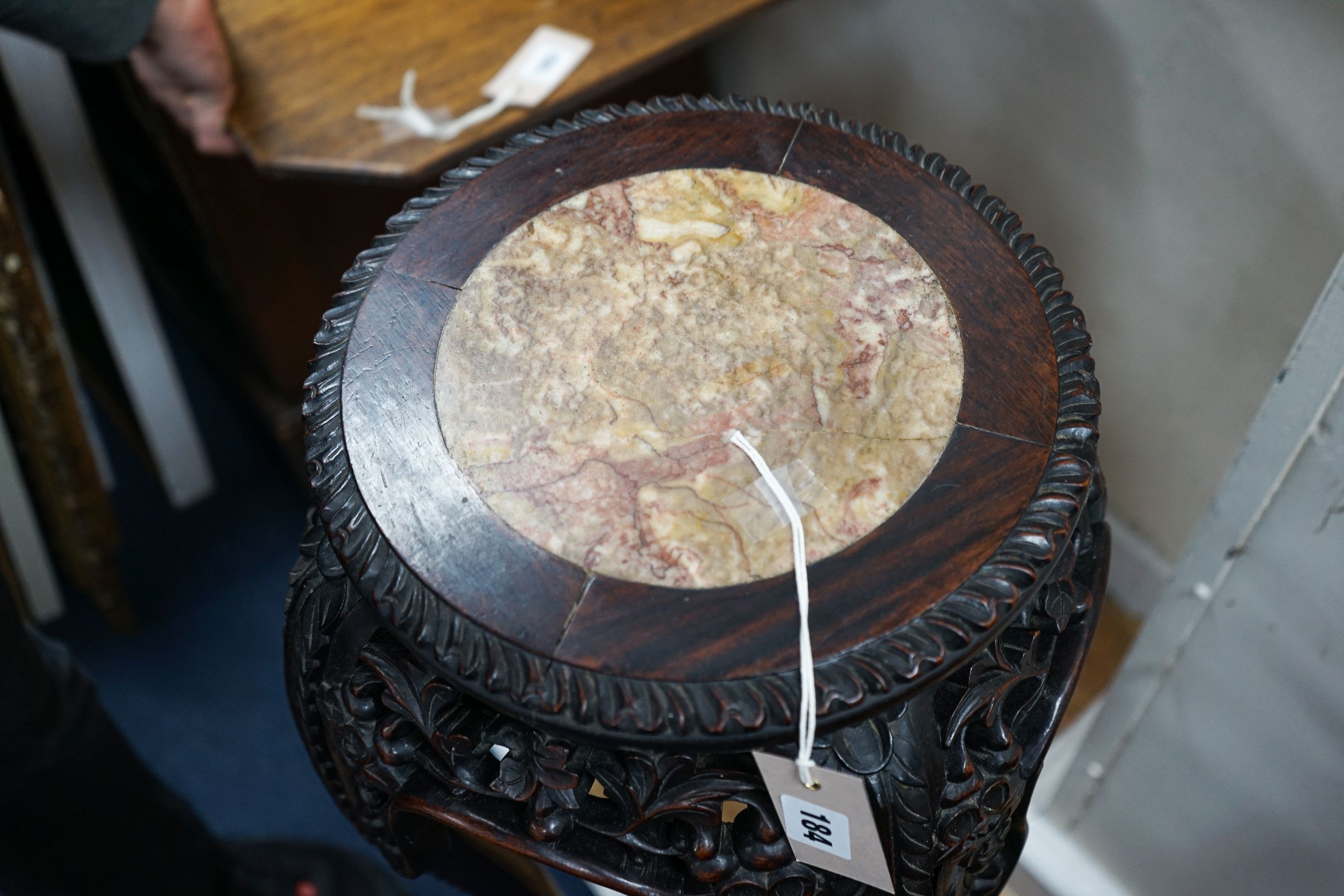 A Chinese circular marble top carved padouk jardiniere stand, height 91cm